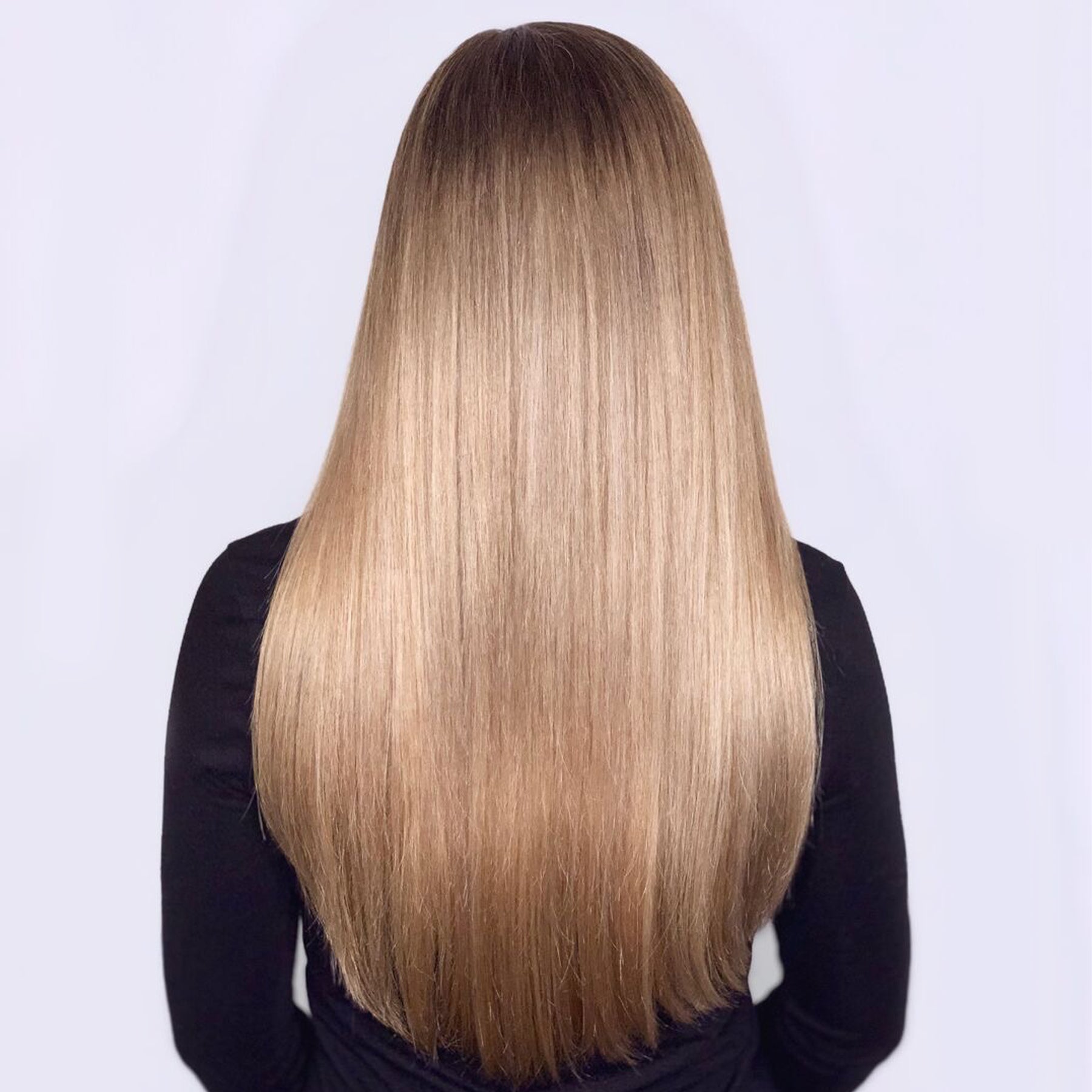 Smooth and shining blonde woman hair after using the Olaplex No. 5 Bond Maintenance Conditioner.